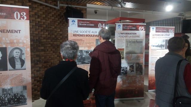 Des visiteurs lisant les panneaux de l’exposition de l’ONACVG.